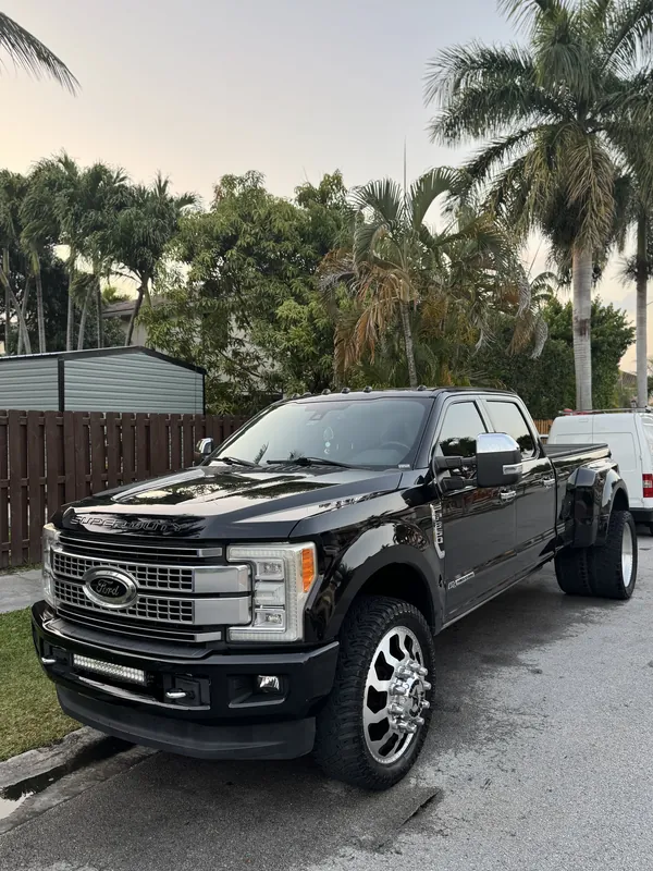 Black Ford Super Duty dually pickup with polished wheels after a full detail